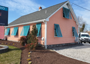 Colorful Bahama shutters adding personality and shade to a beach-style home.