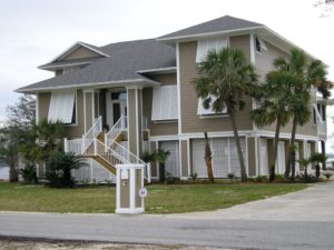 Modern home exterior featuring custom Bahama shutters angled to reduce heat and glare.
