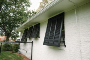 Bahama shutters closed over windows for added protection during storms.